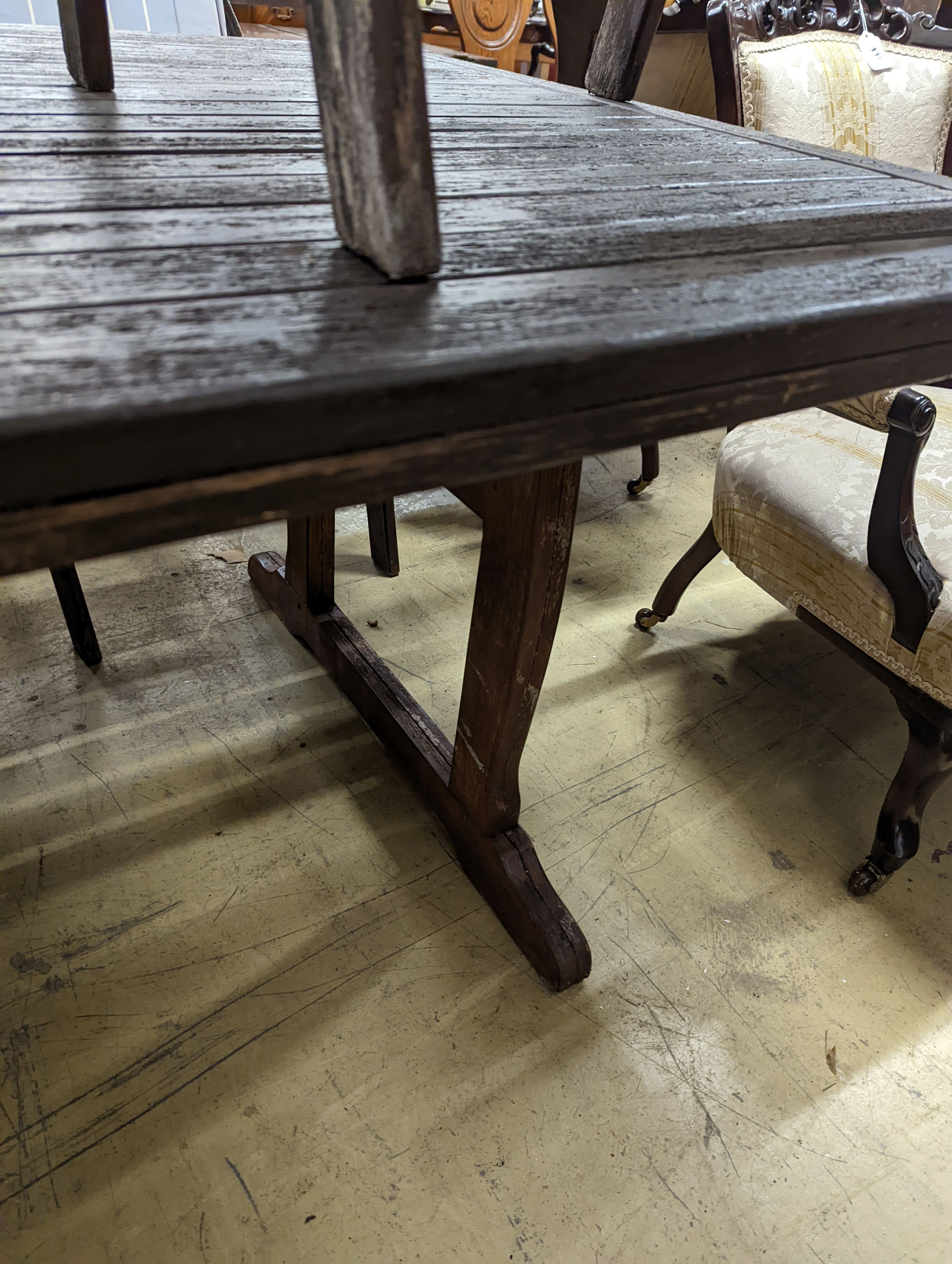 A Fechters stained teak rectangular garden table, length 220cm, depth 107cm, height 72cm and eight elbow chairs and seat pads